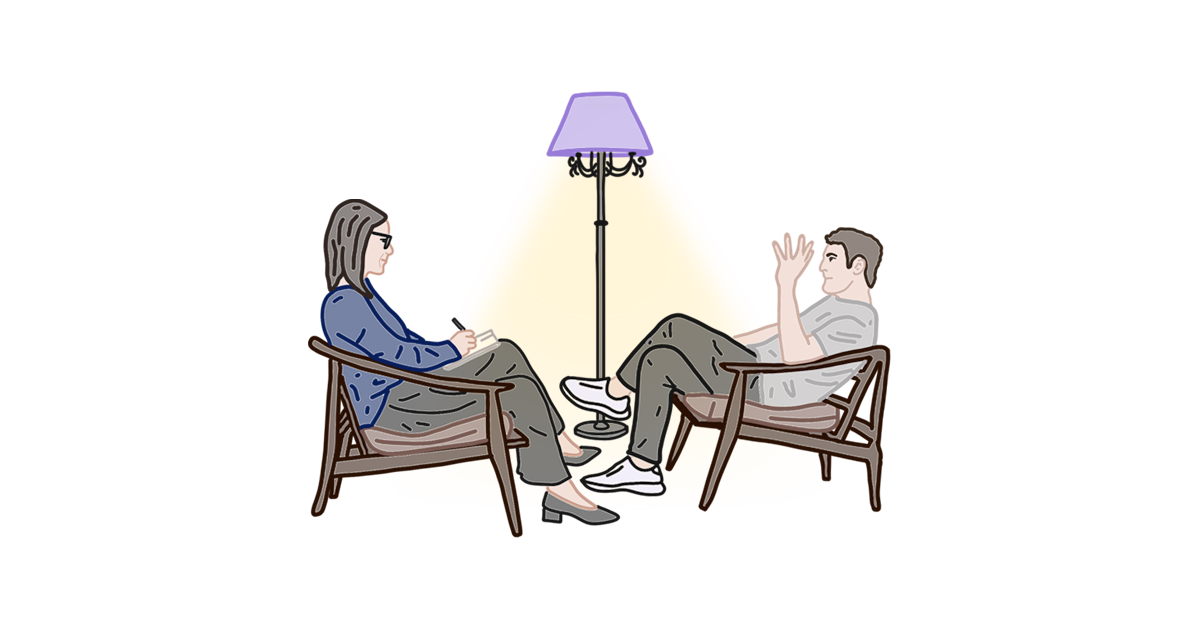 Дві людини сидять у кріслах, між ними торшер
